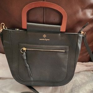 Black Nanette lepore purse with wooden handles and adjustable detachable strap